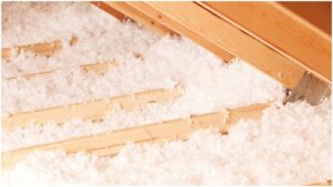 Loose-fill fiberglass insulation along the floor of an attic